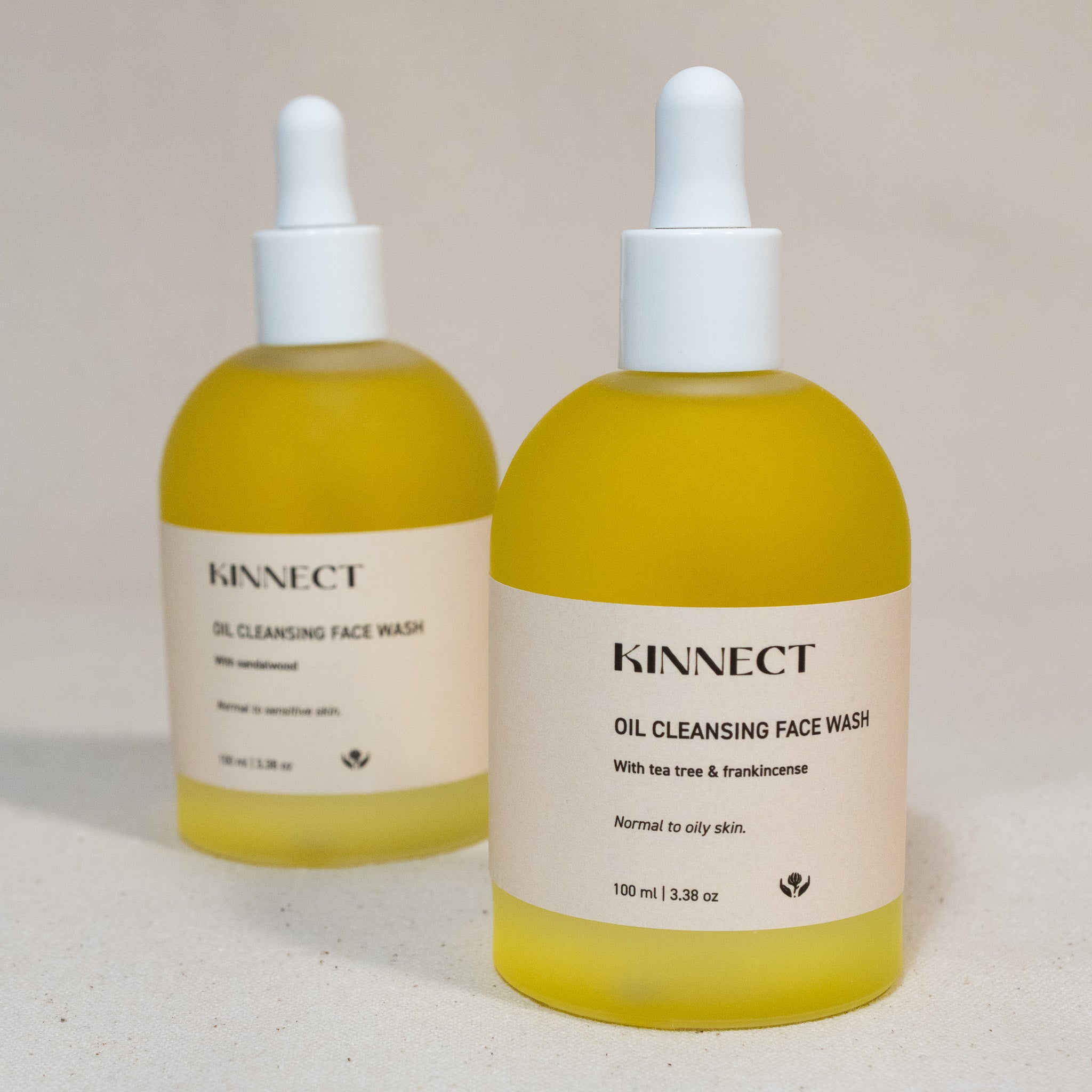 Two bottles of Kinnect Oil Cleansing Face Wash on a neutral background