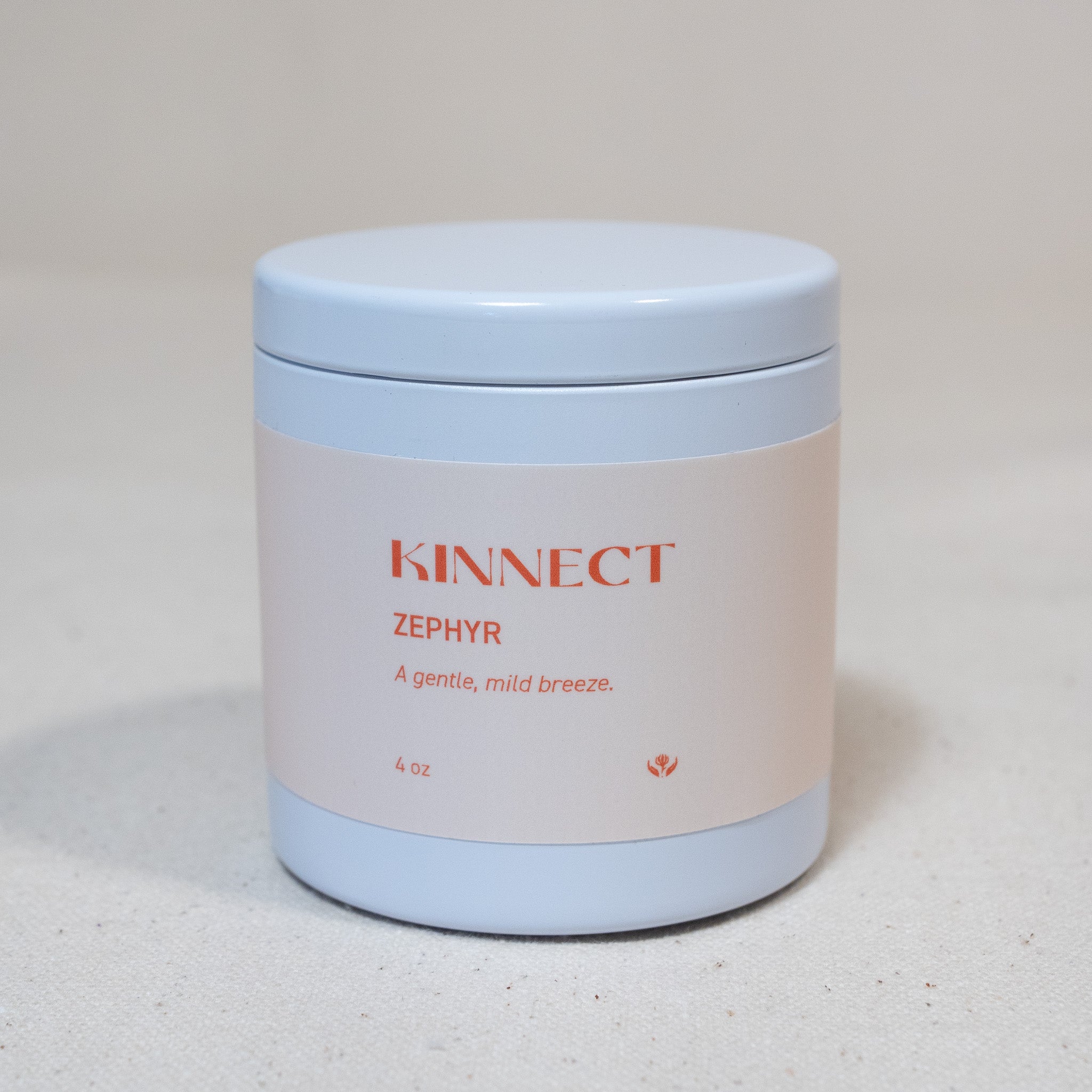 Candle jar labeled 'KINNECT Zephyr' on a light background