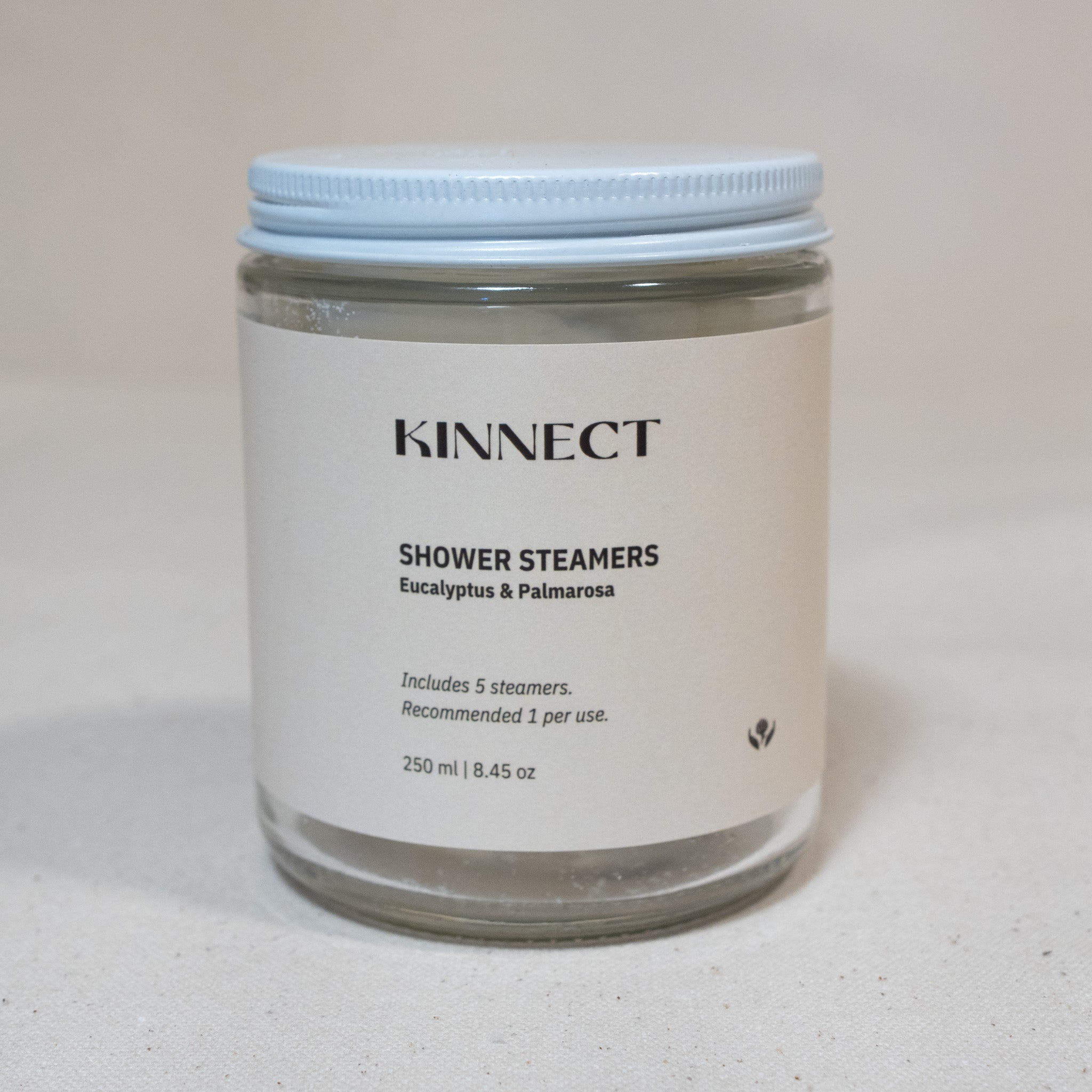 Jar of Kinnect shower steamers with a white lid on a white background