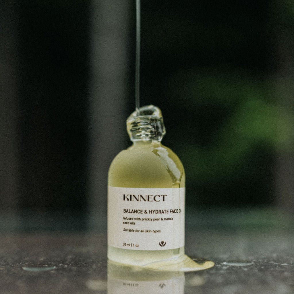 Opened balance and hydrate face oil with product dripping down the side of the bottle