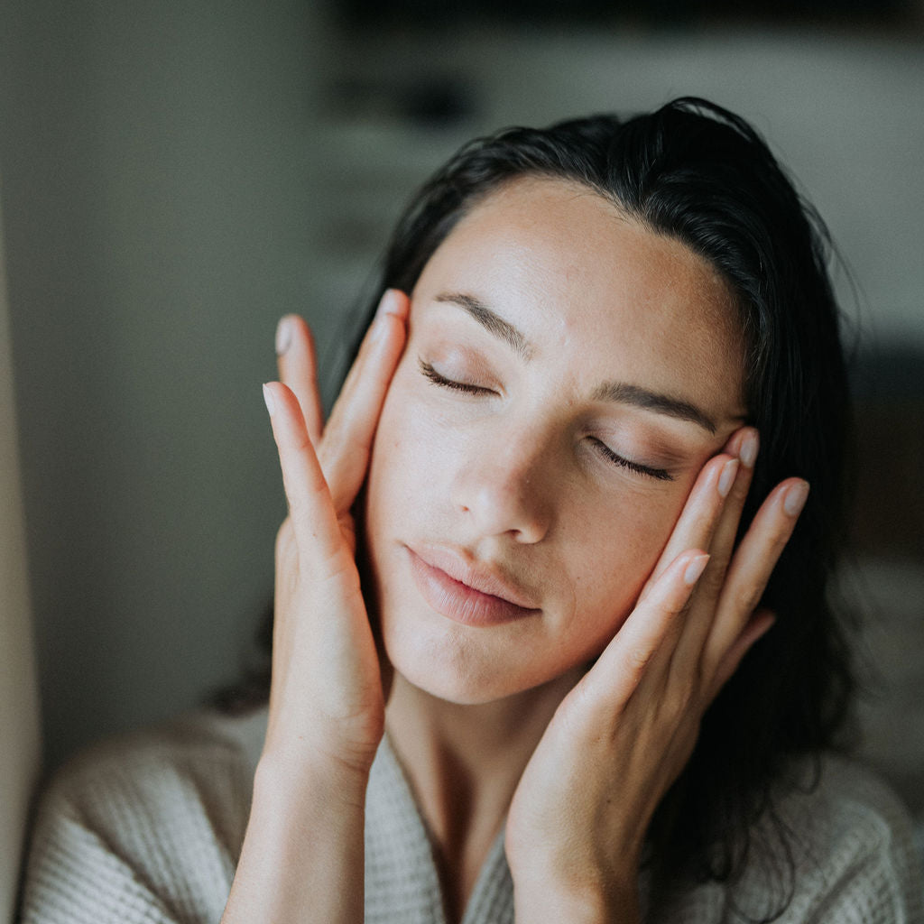 Serene Model rubs the balance and hydrate face oil into her skin