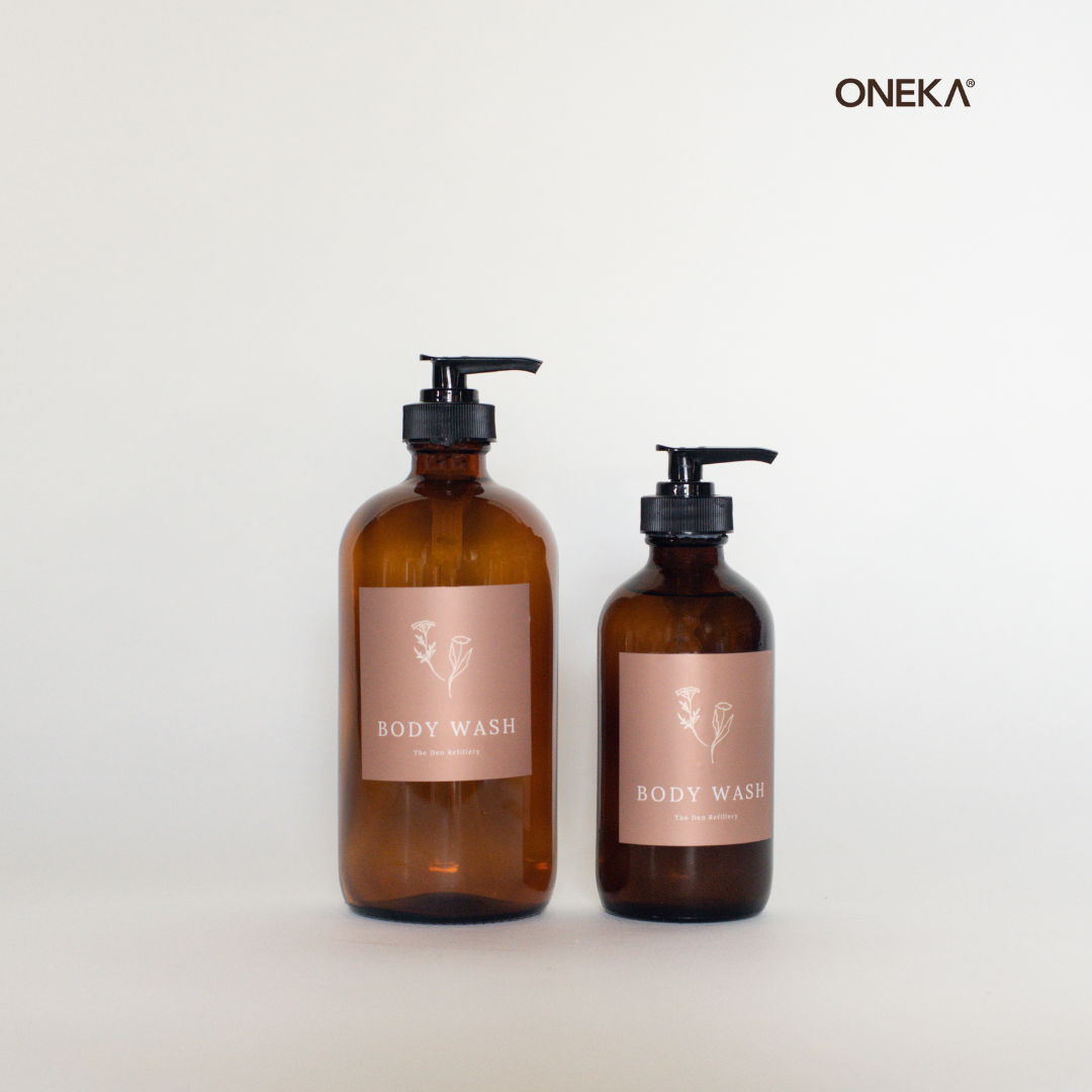 ONEKA Body Wash in a 250ml and 500ml amber glass bottle in a white room