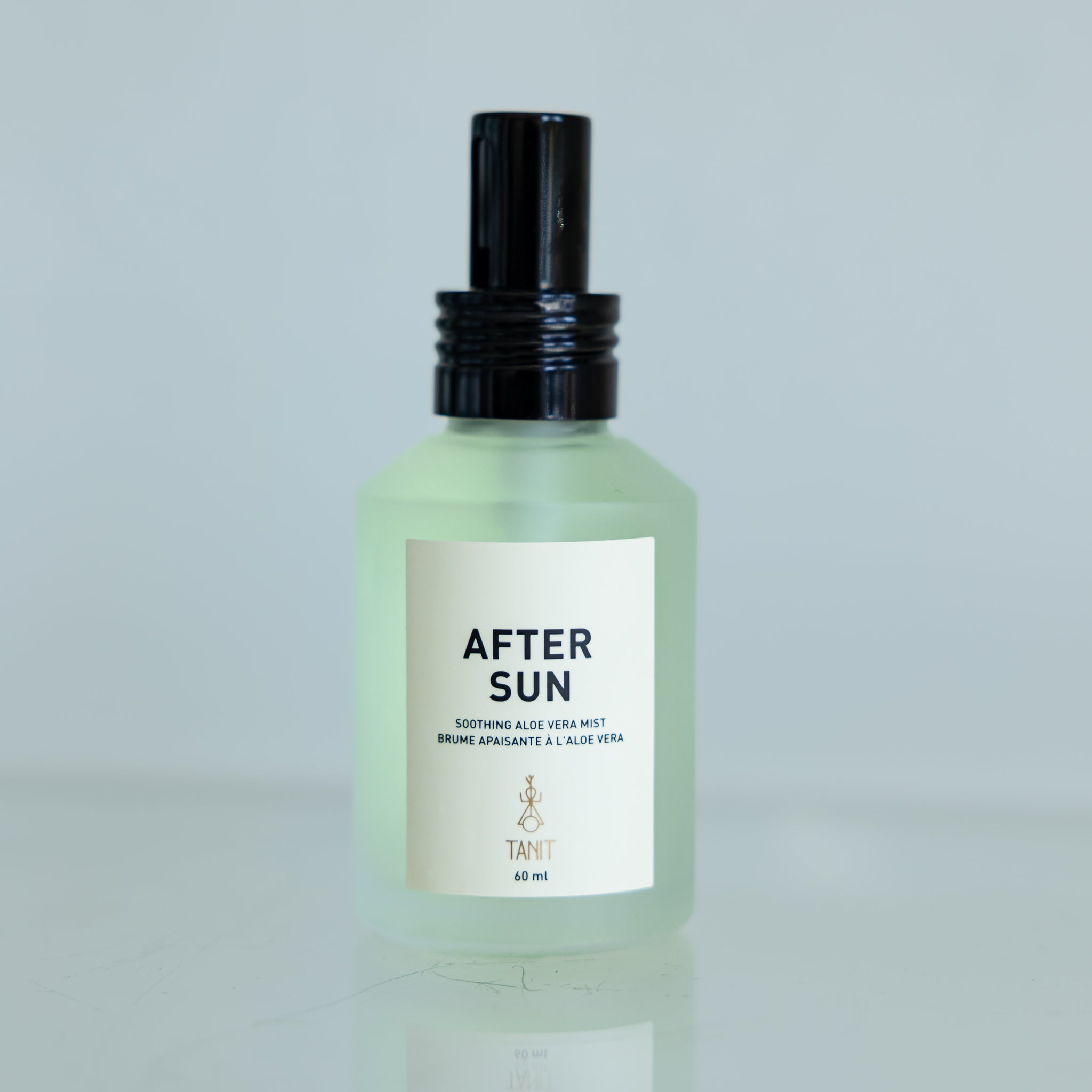 TANIT After Sun glass spritz bottle with a white background. The Label reads: “Soothing aloe vera mist” 