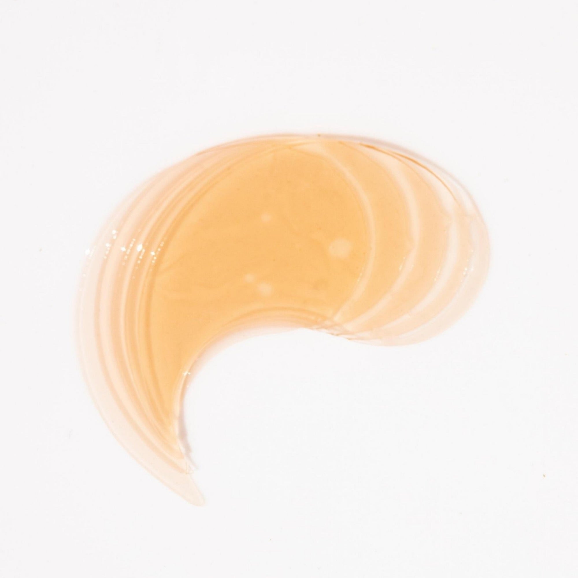 The orange biodegradable eye masks are splayed out on a white surface
