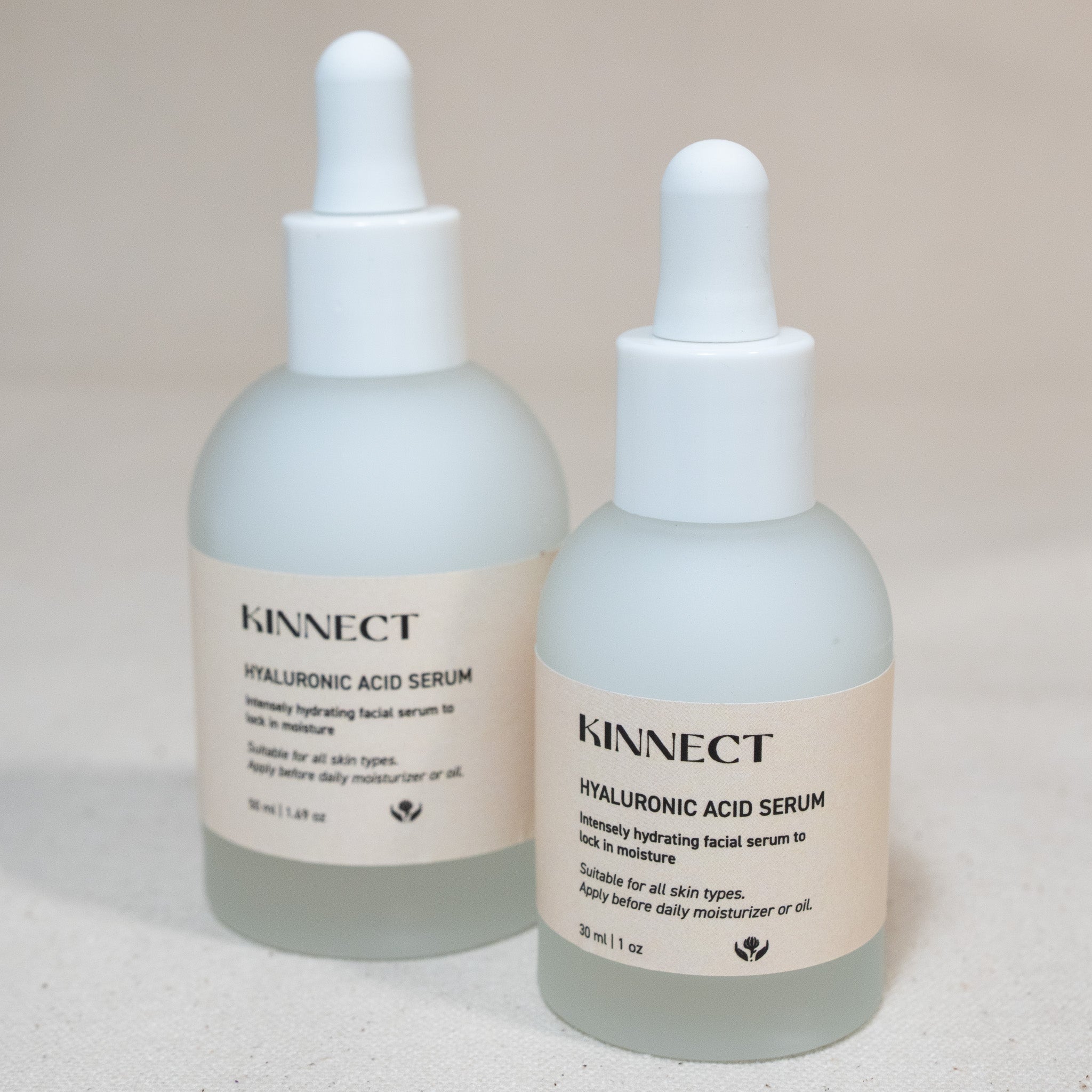 Two bottles of Kinnect Hyaluronic Acid Serum on a neutral background