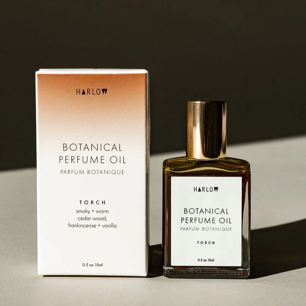 Botanical perfume oil bottle and packaging with 'Harlow' branding on a neutral background