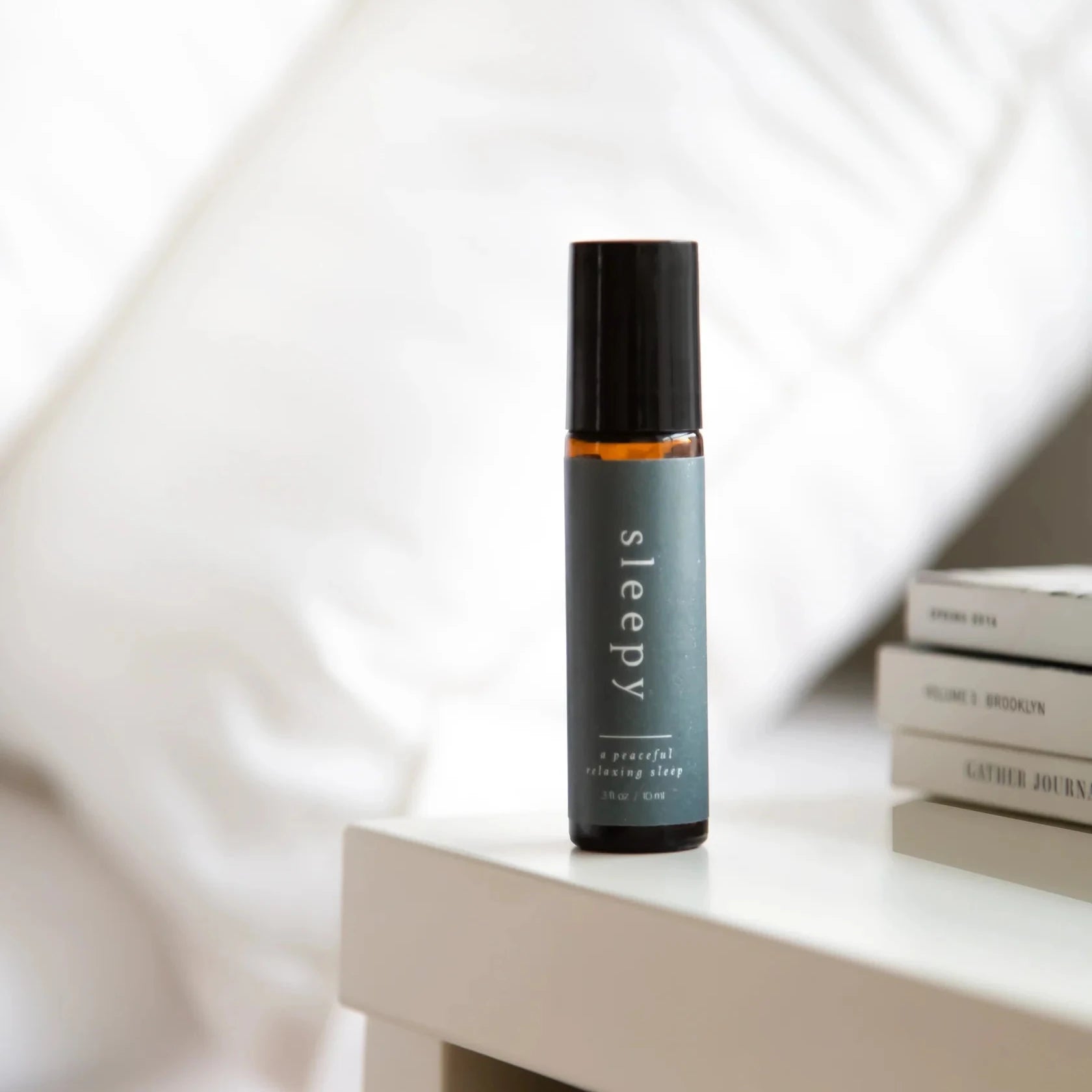 Bottle of 'sleepy' roll-on on a table with a blurred background