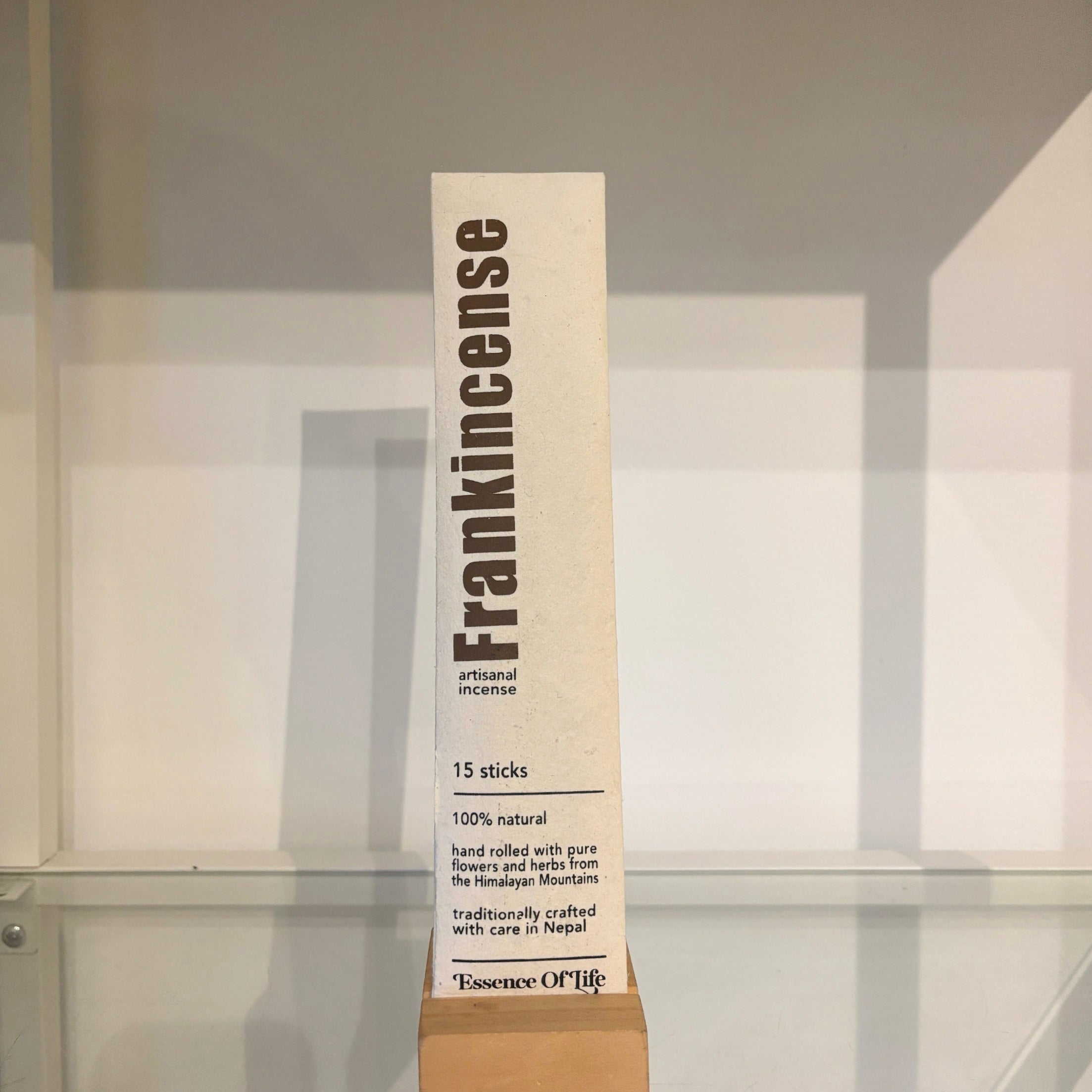 Frankincense incense stick packaging on a reflective surface