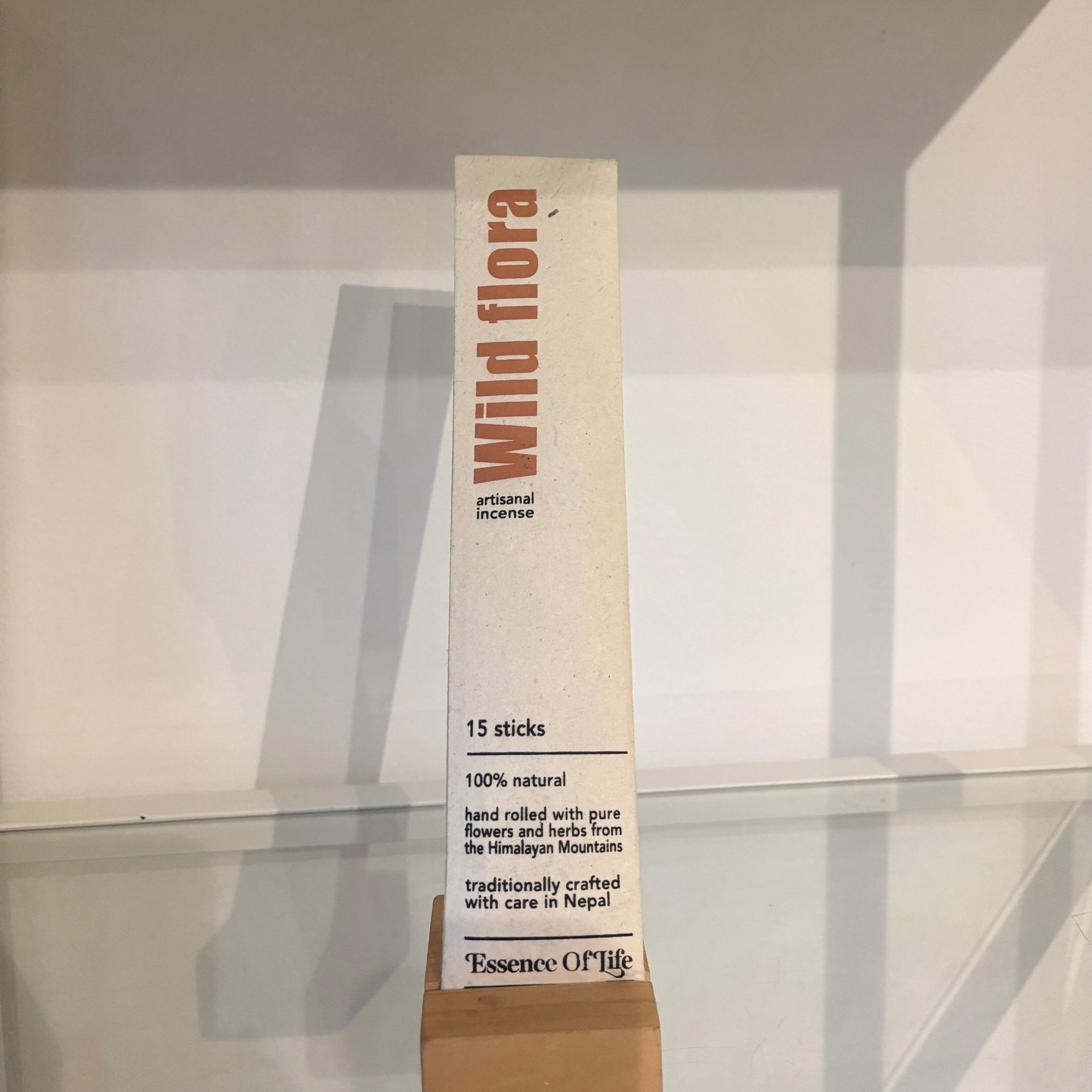 Product packaging with 'Wild flora' branding on a reflective surface