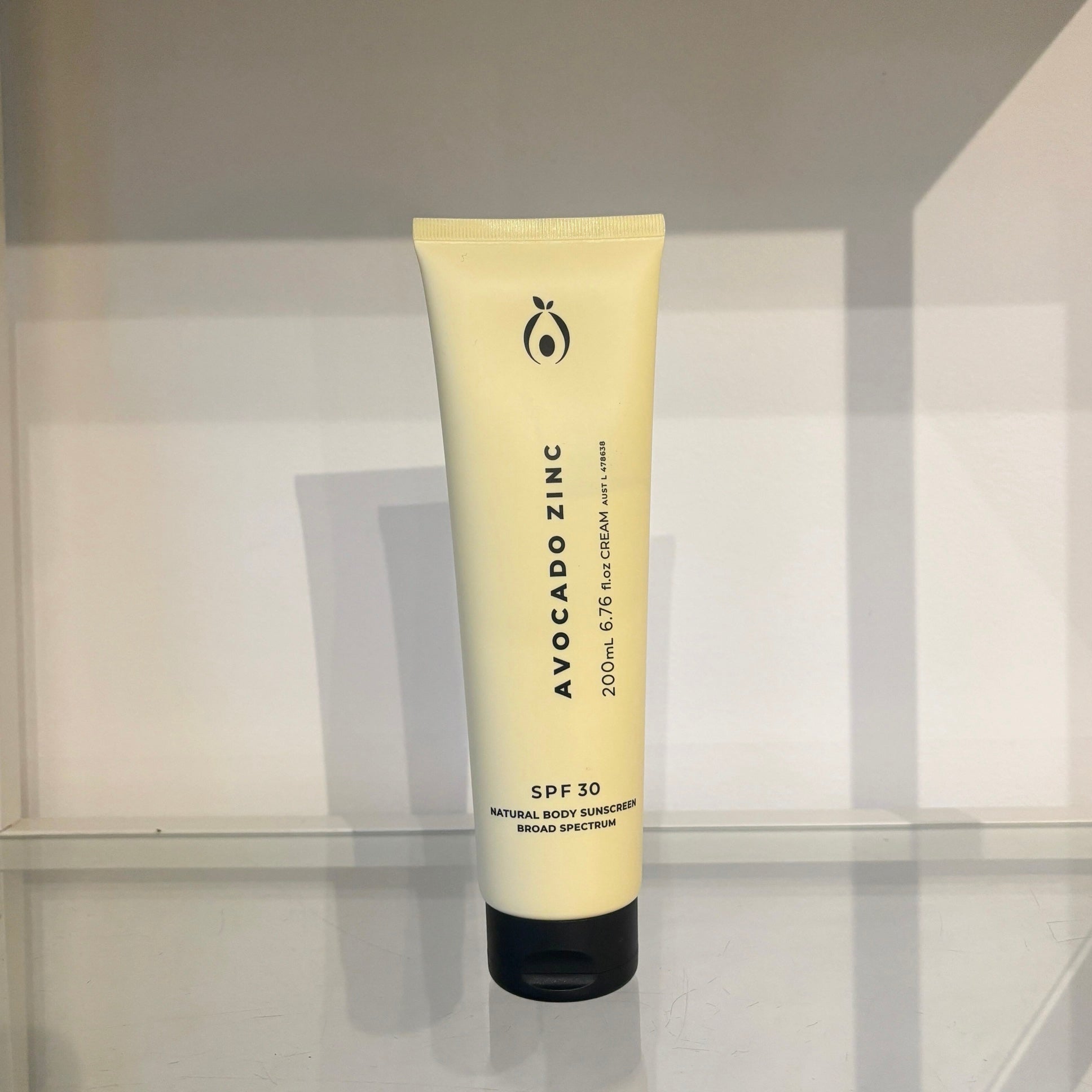 Tube of Avocado Zinc sunscreen on a reflective surface