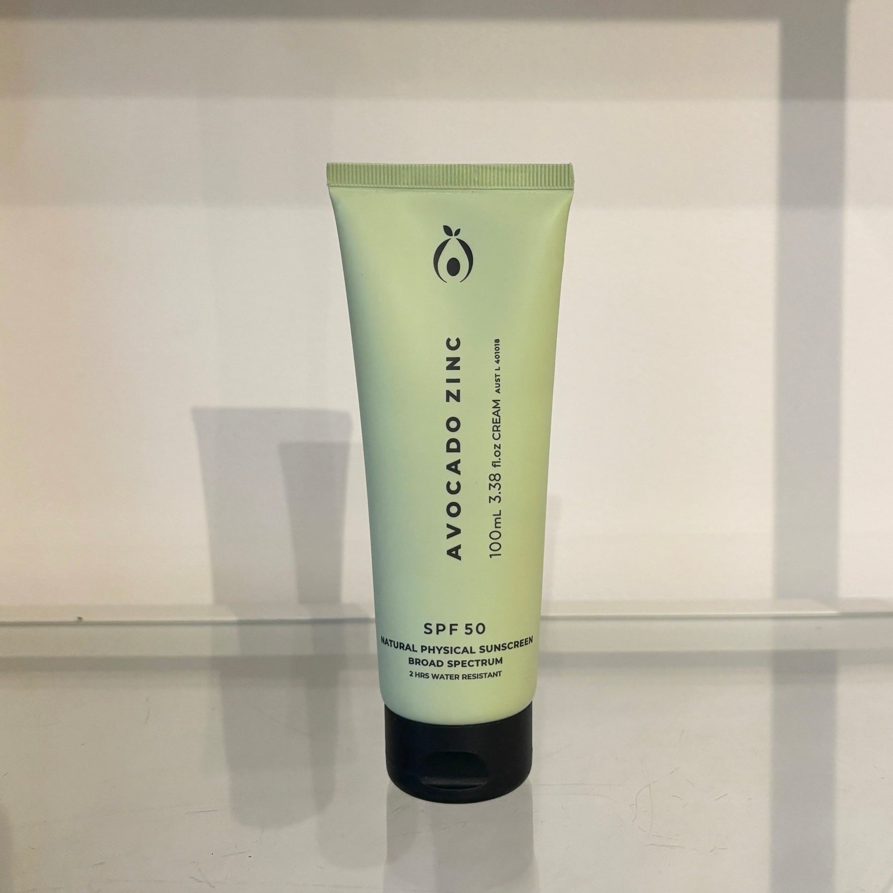 Tube of Avocado Zinc sunscreen on a white surface with a neutral background