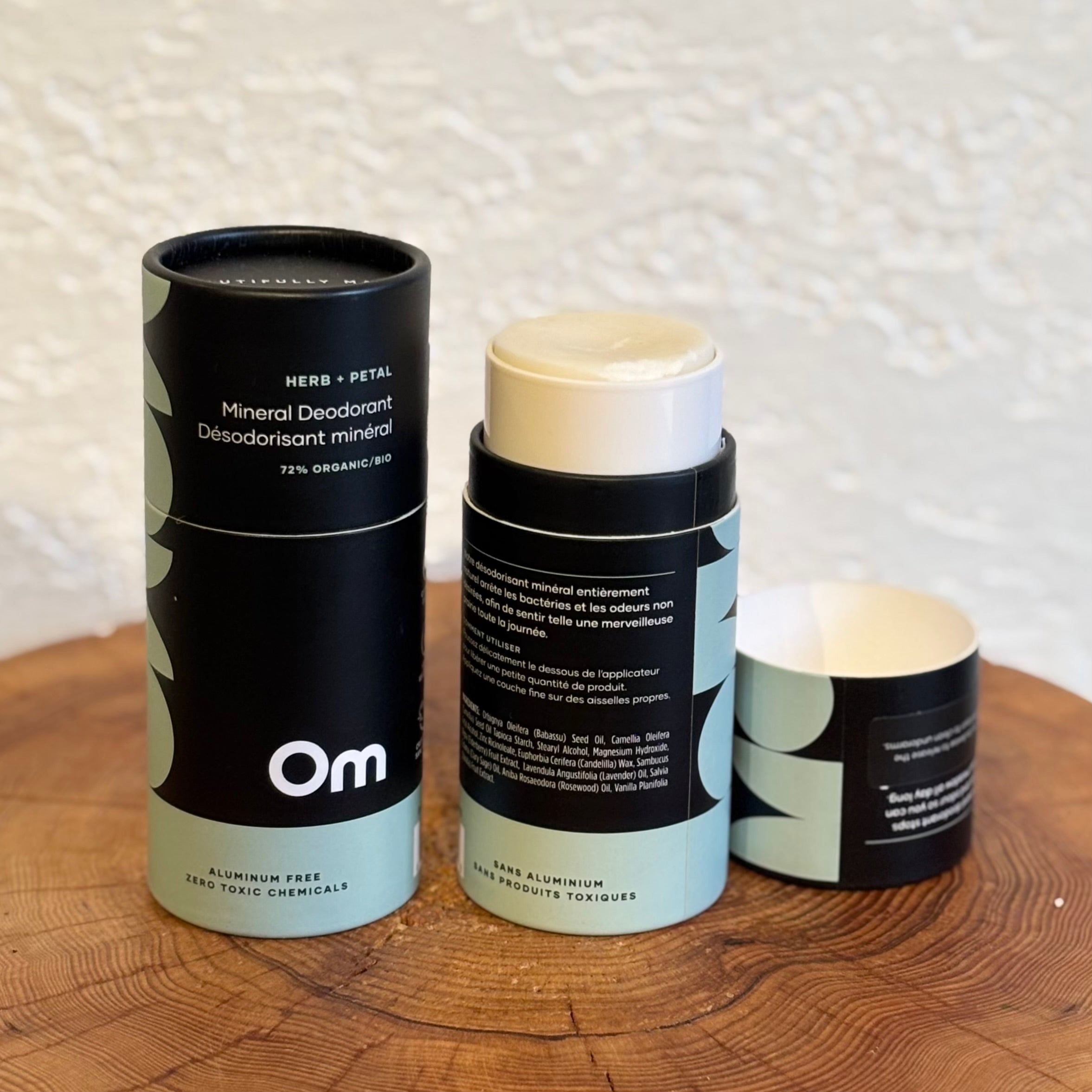 Three cylindrical containers with black and white labels on a wooden surface.