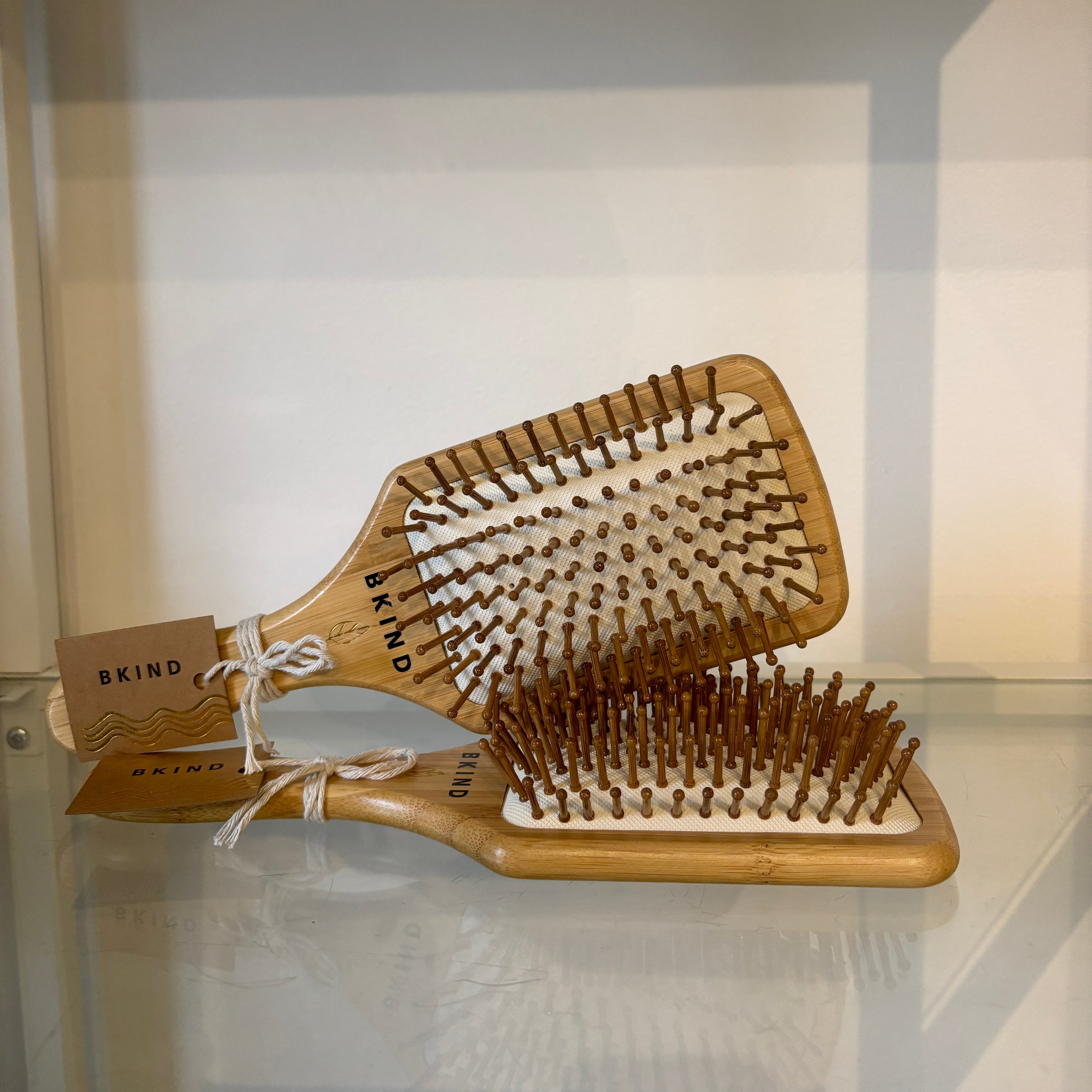 Wooden paddle brush with bristles on a white background