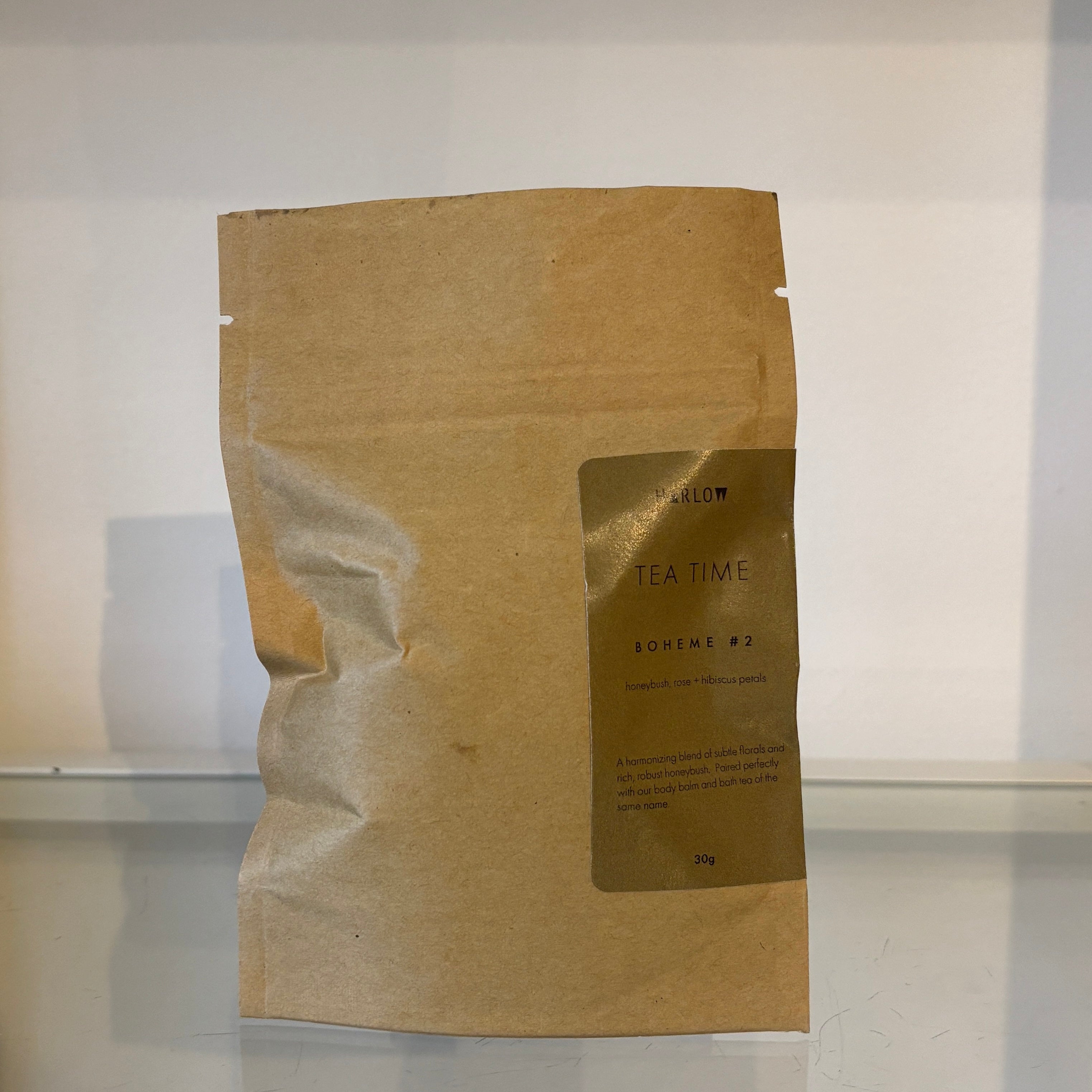 Brown paper bag with tea packaging on a white background