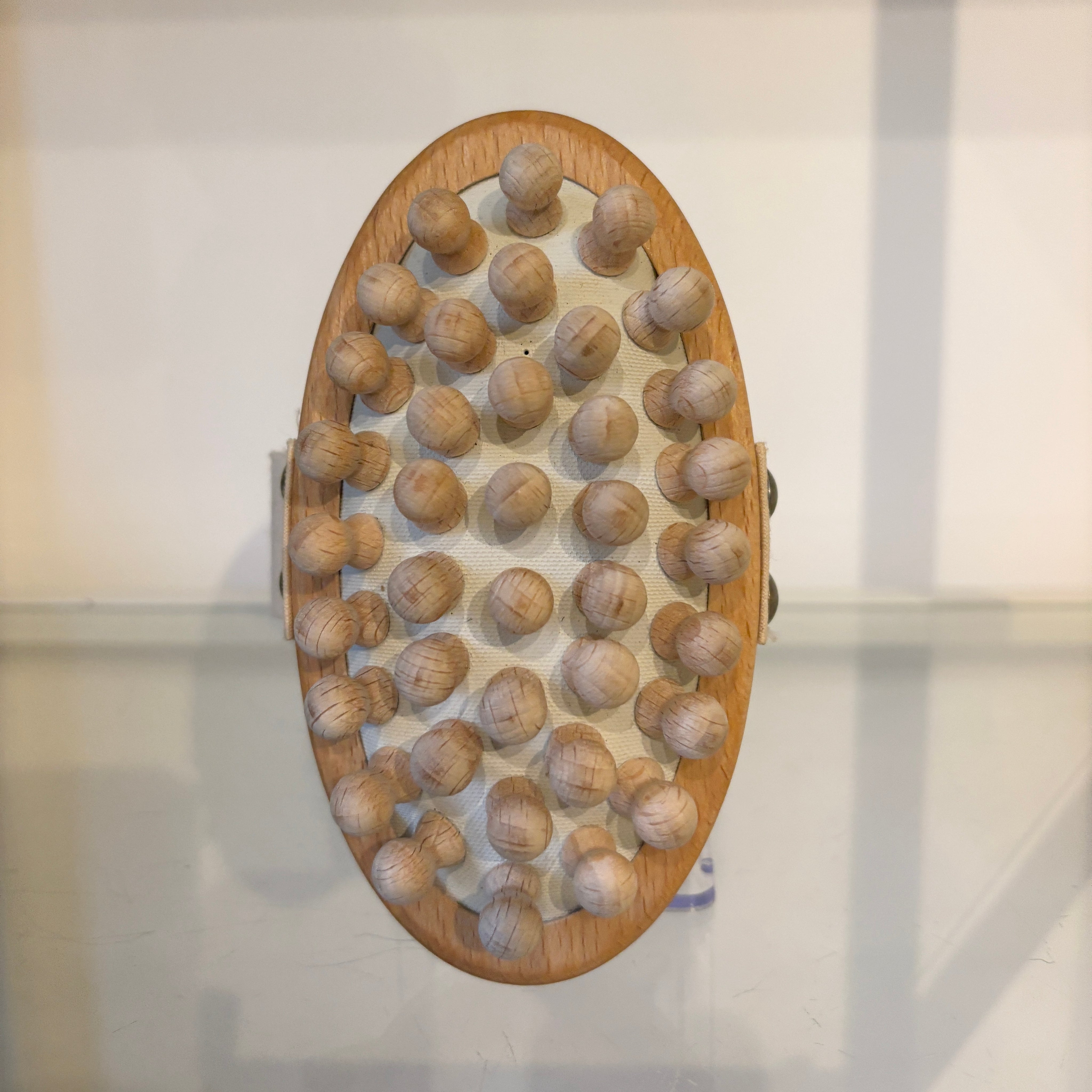 Wooden brush with raised nodes on a white background