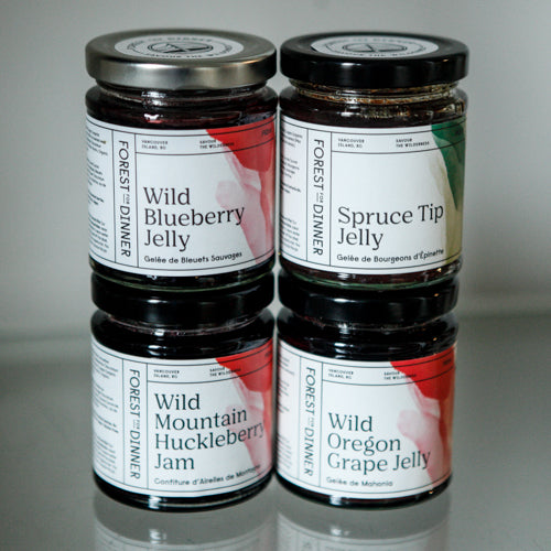 A selection of the most popular preserves and jams: wild blueberry jelly, spruce tip jelly, wild mountain huckleberry jam, and wild Oregon grape jelly 