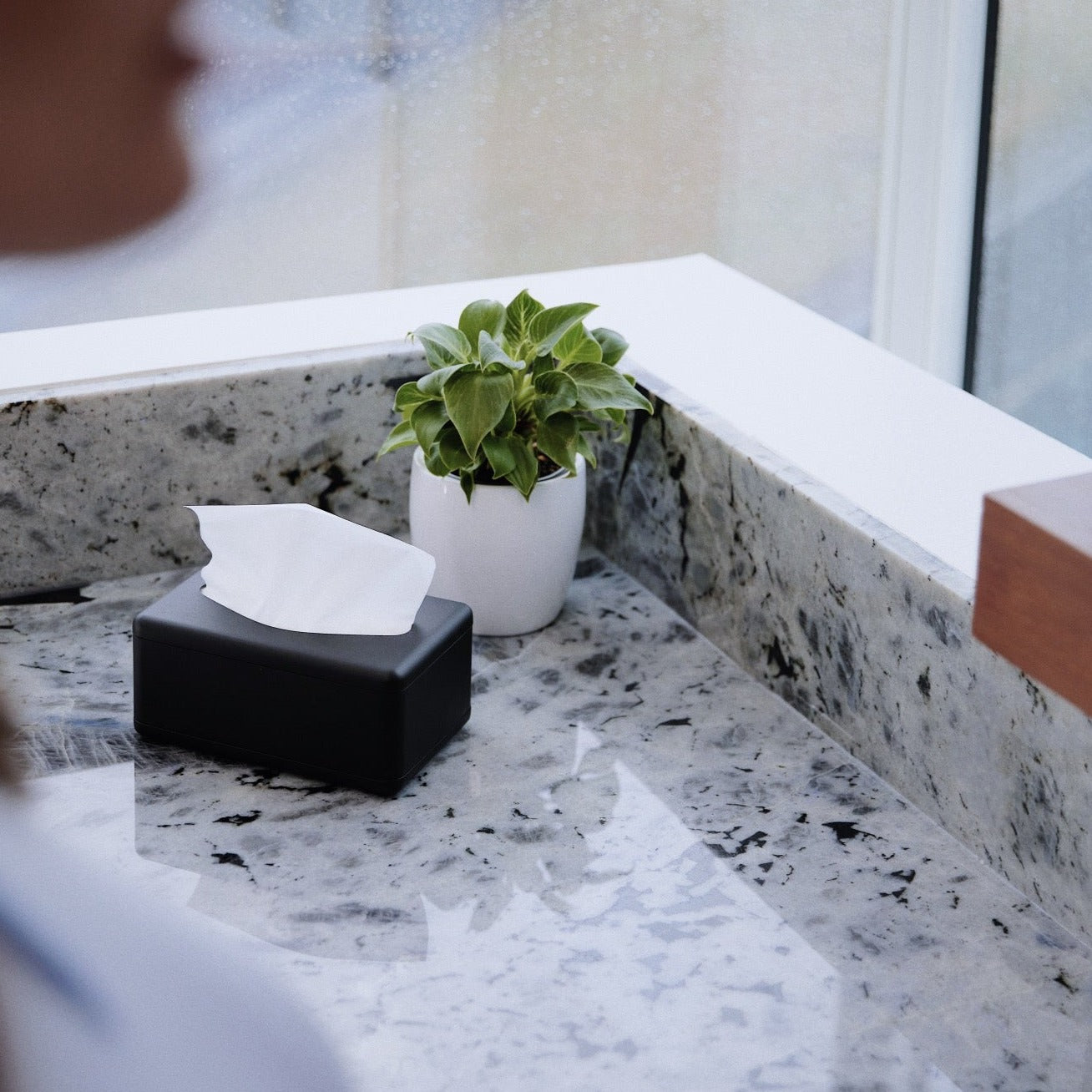 Black fox fold tissue dispenser on a bathroom counter 
