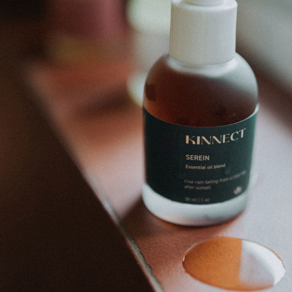Bottle of Kinnect serein essential oil blend on a wooden surface