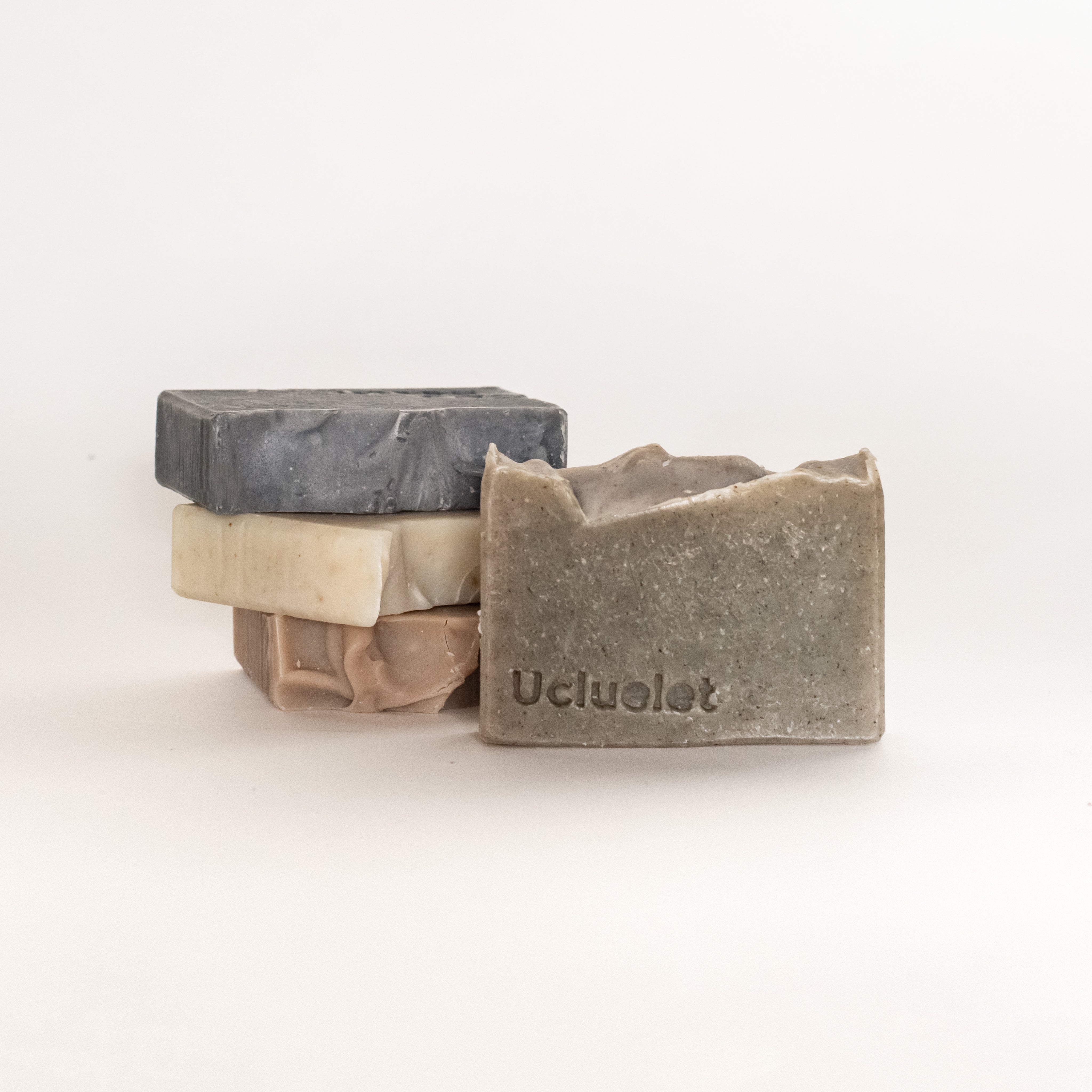 A few beach soaps stacked on top of one another. In the background from top to bottom: Big Beach, Long Beach, and Florencia. In the foreground is the Ucluelet beach soap.