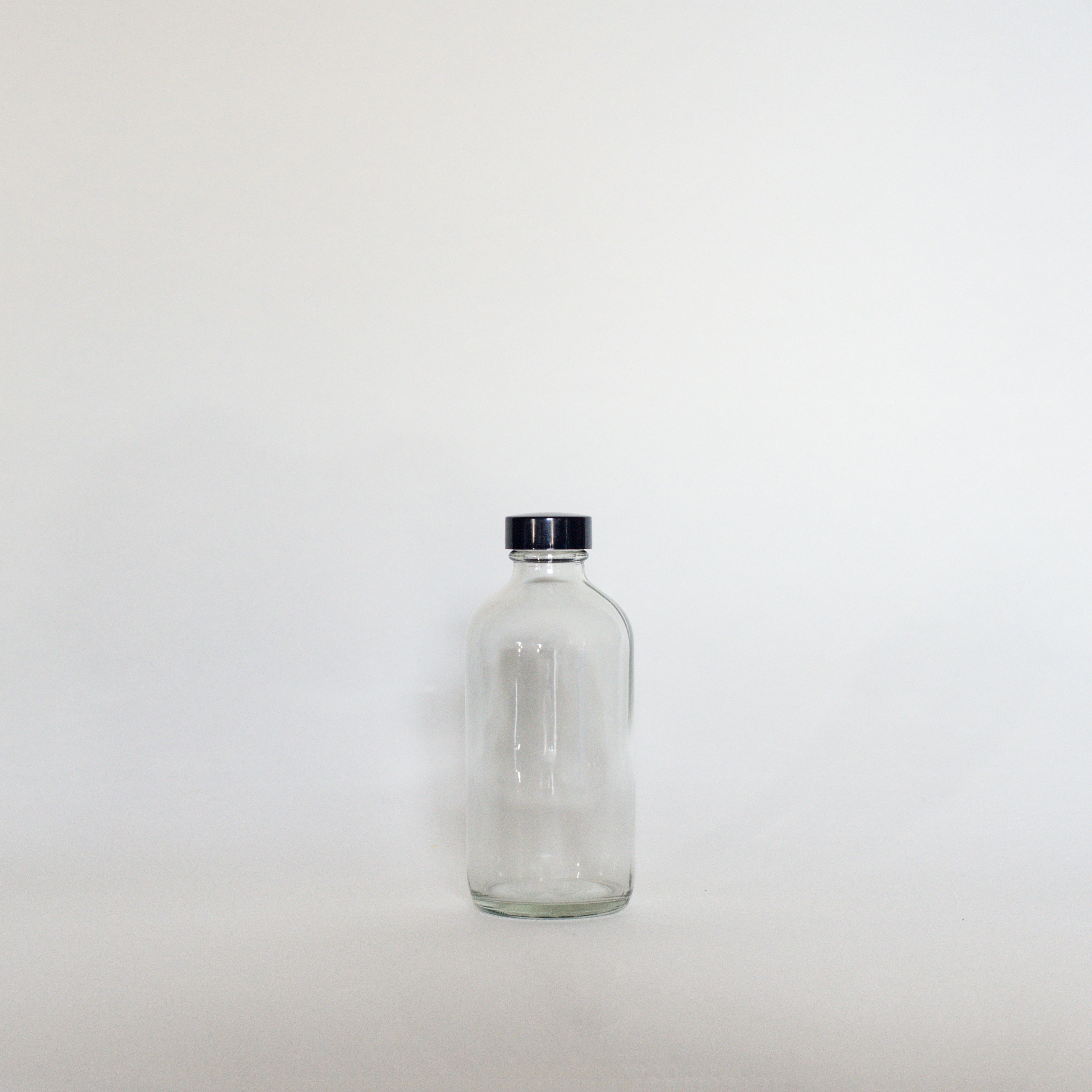 Clear Glass Bottles - The Den Ucluelet