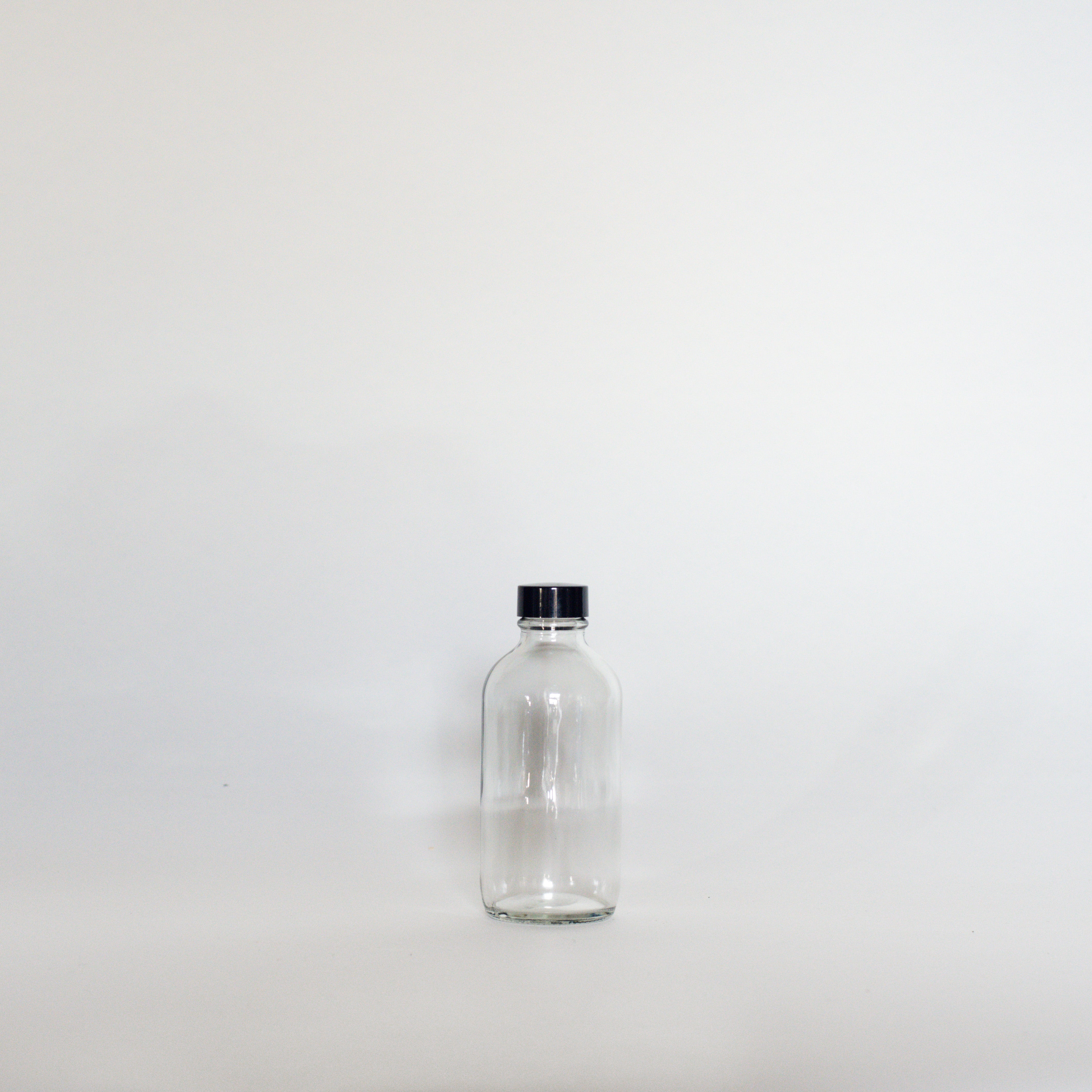 Clear Glass Bottles - The Den Ucluelet