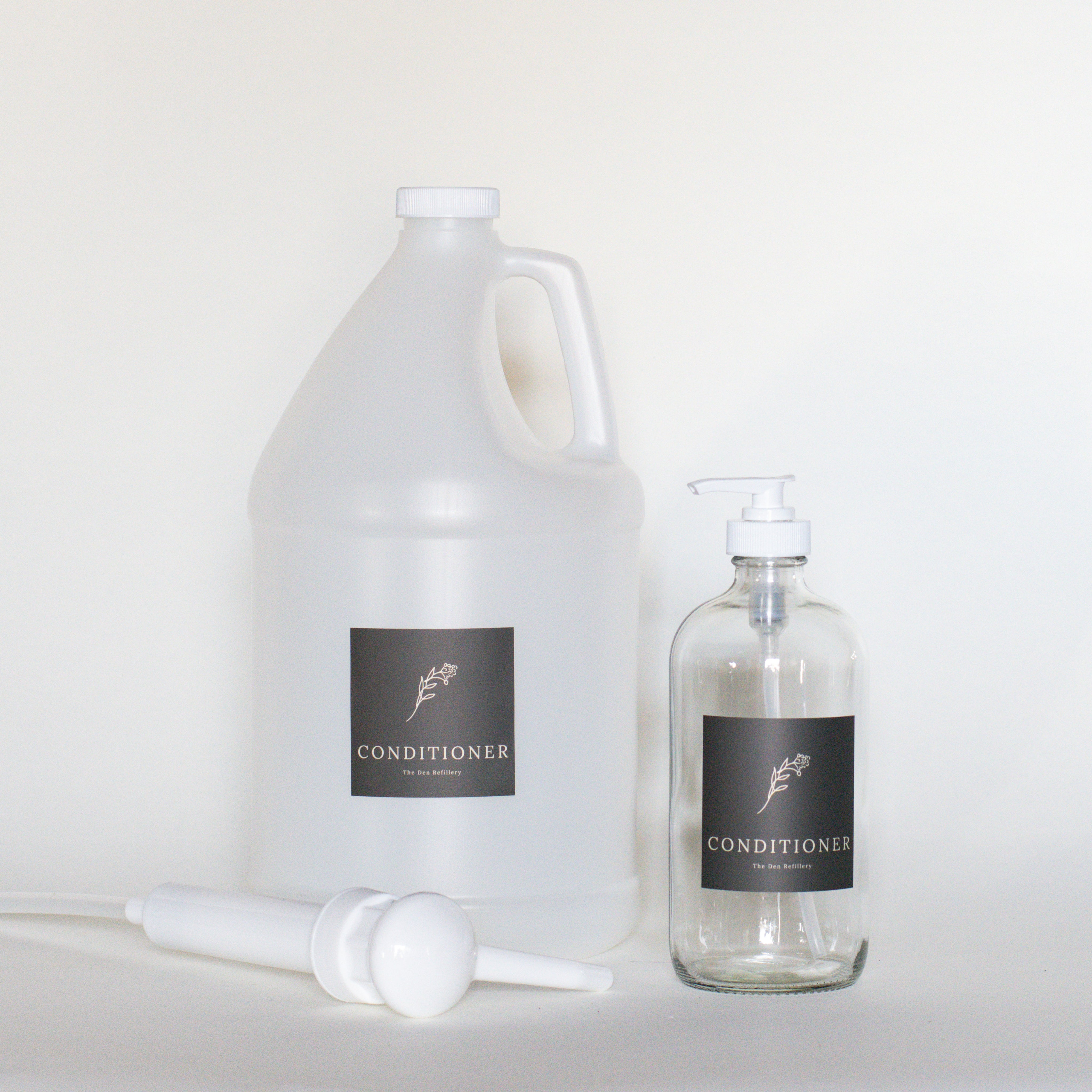 The Den Refillery Conditioner Kit with a clear glass bottle