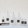 The Den Refillery Bathroom Refill Kit with clear glass bottles.